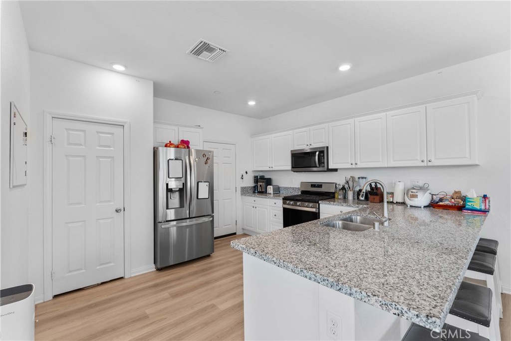 1634 Crepe Myrtle Place Upland, CA 91784 - Photo 8 of 41 a kitchen with stainless steel appliances granite countertop a refrigerator and a sink