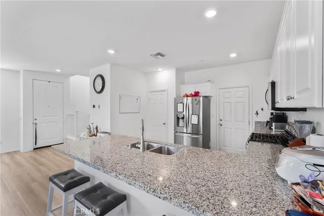 a large kitchen with a stove a sink and a refrigerator