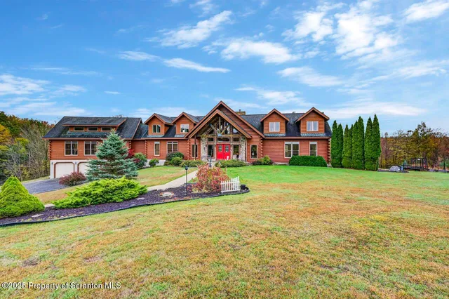 a front view of house with yard and green space