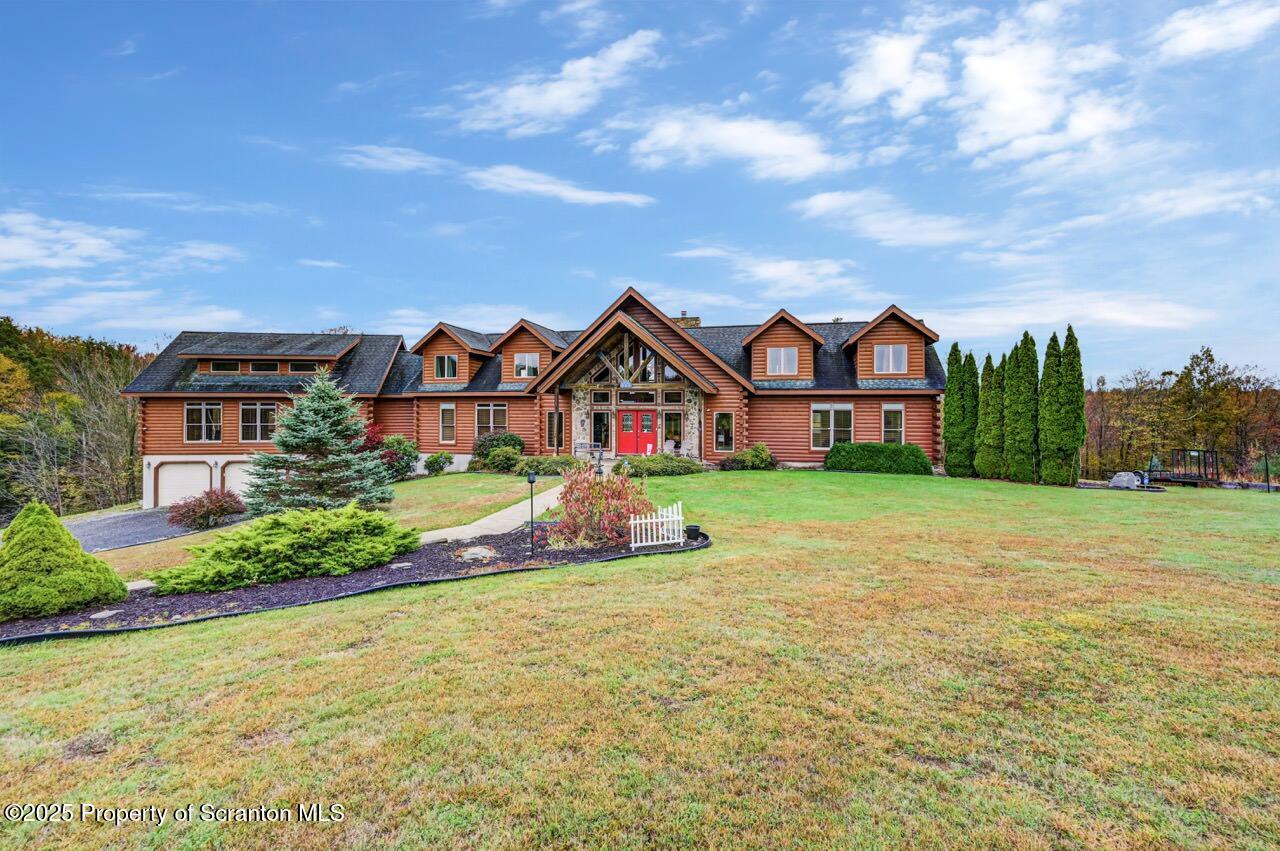a front view of house with yard and green space
