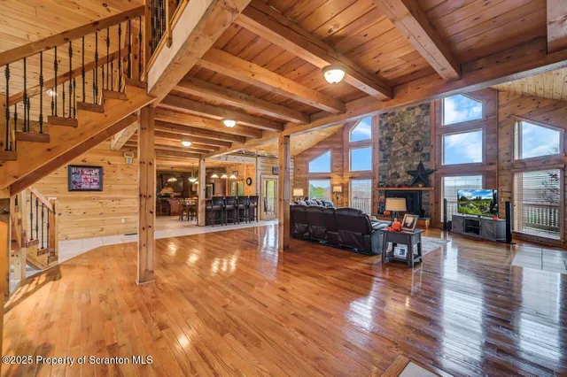 a kitchen with stainless steel appliances kitchen island granite countertop a table chairs and a refrigerator