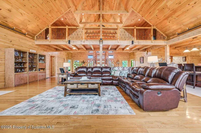 a view of a dining room with furniture a chandelier and kitchen view