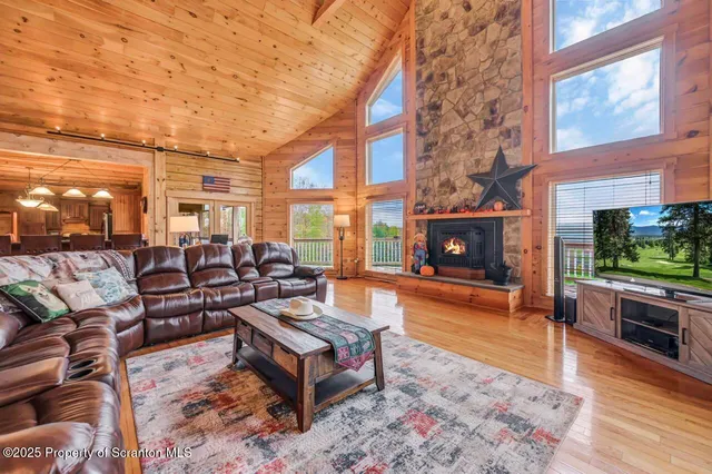 a view of a dining room with furniture and chandelier