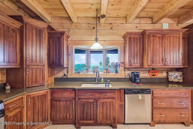a bathroom with a granite countertop sink a toilet and shower
