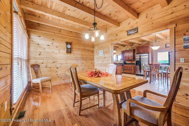a living room with furniture a wooden floor and a large window