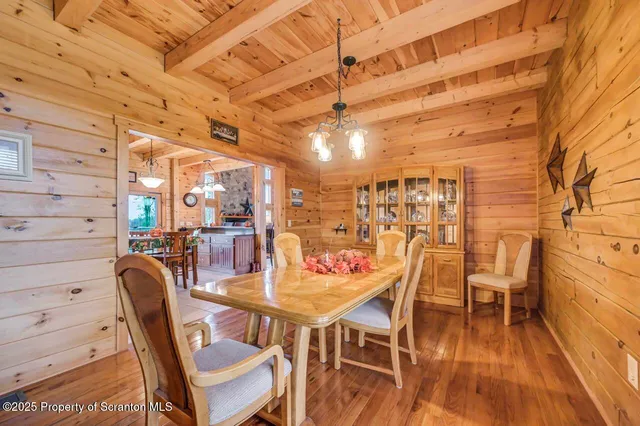 a room with pool table and wooden floor