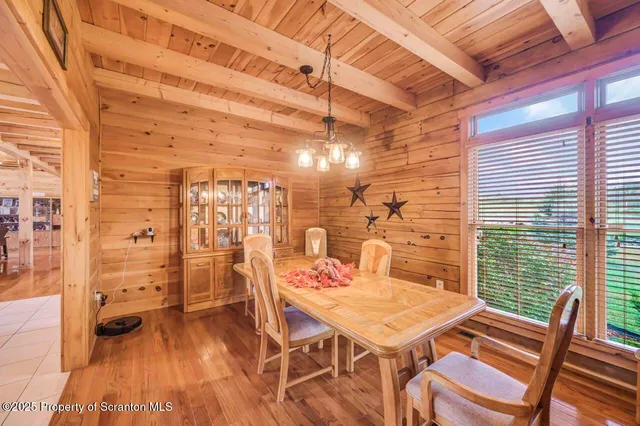 a room with pool table and windows