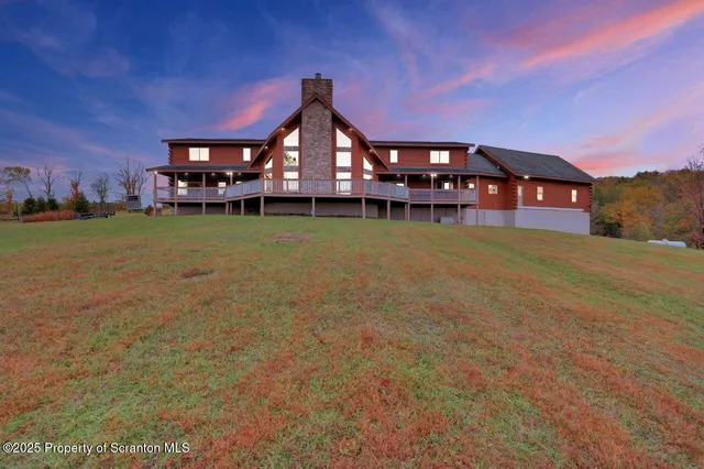 a front view of a house with a garden and deck