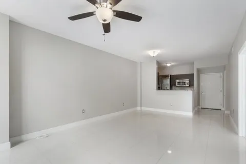 an empty room with a empty space and a ceiling fan