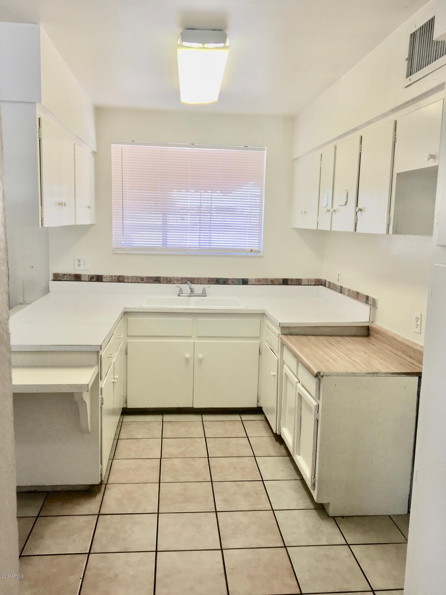 5354 West Osborn Road Phoenix, AZ 85031 - Photo 6 of 21 a utility room with cabinets washer and dryer