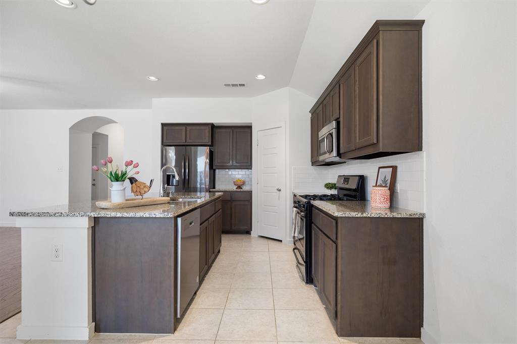 1620 Meadow Trail Lane Aubrey, TX 76227 - Photo 11 of 29 Modern kitchen with rich dark cabinetry!