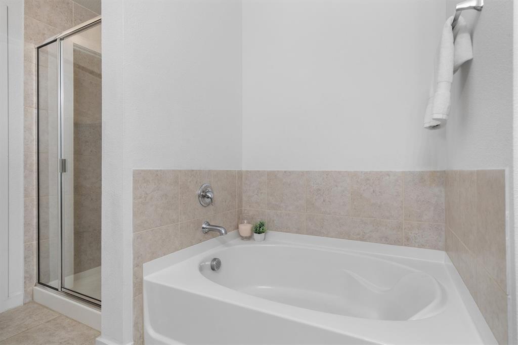 1620 Meadow Trail Lane Aubrey, TX 76227 - Photo 19 of 29 Enjoy a spacious walk-in shower and a relaxing bathtub for a spa-like experience.
