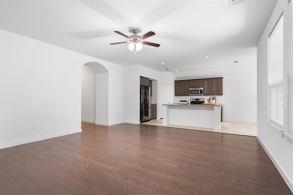 1620 Meadow Trail Lane Aubrey, TX 76227 - Photo 8 of 29 Seamlessly connected to the kitchen, it’s perfect for entertaining and everyday living.