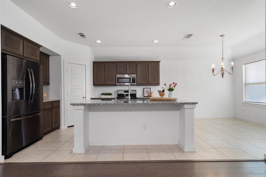 1620 Meadow Trail Lane Aubrey, TX 76227 - Photo 9 of 29 Large island perfect for casual dining.