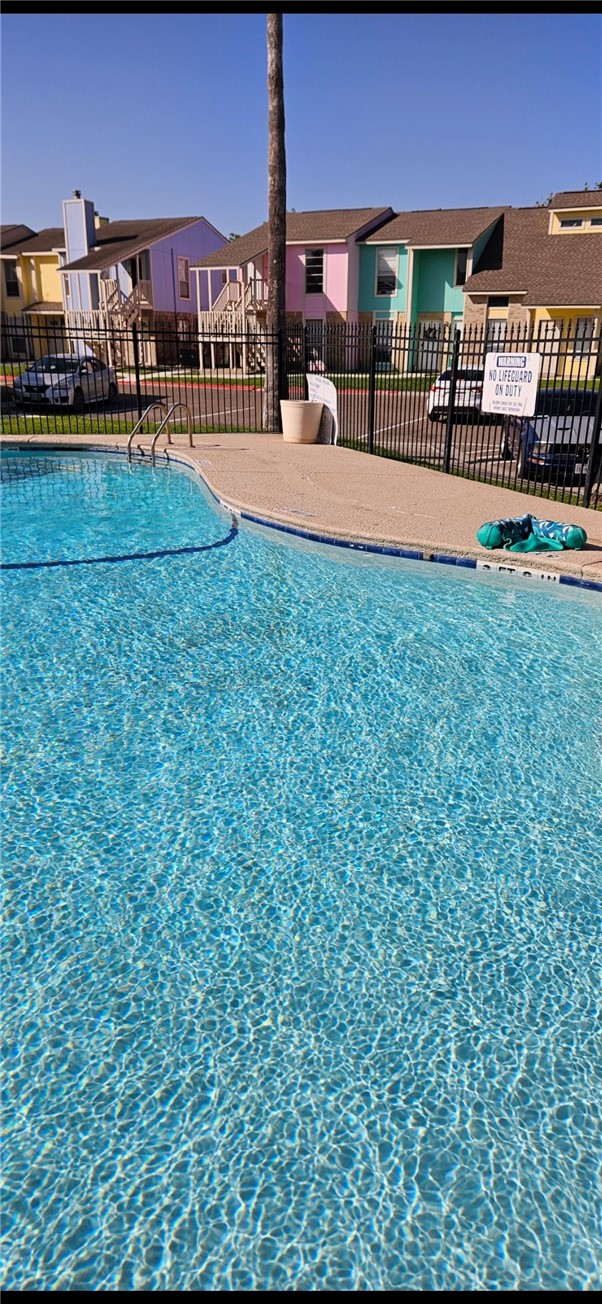 6702 Everhart Road, Unit K 104 Corpus Christi, TX 78413 - Photo 2 of 13 a swimming pool view with a outdoor seating