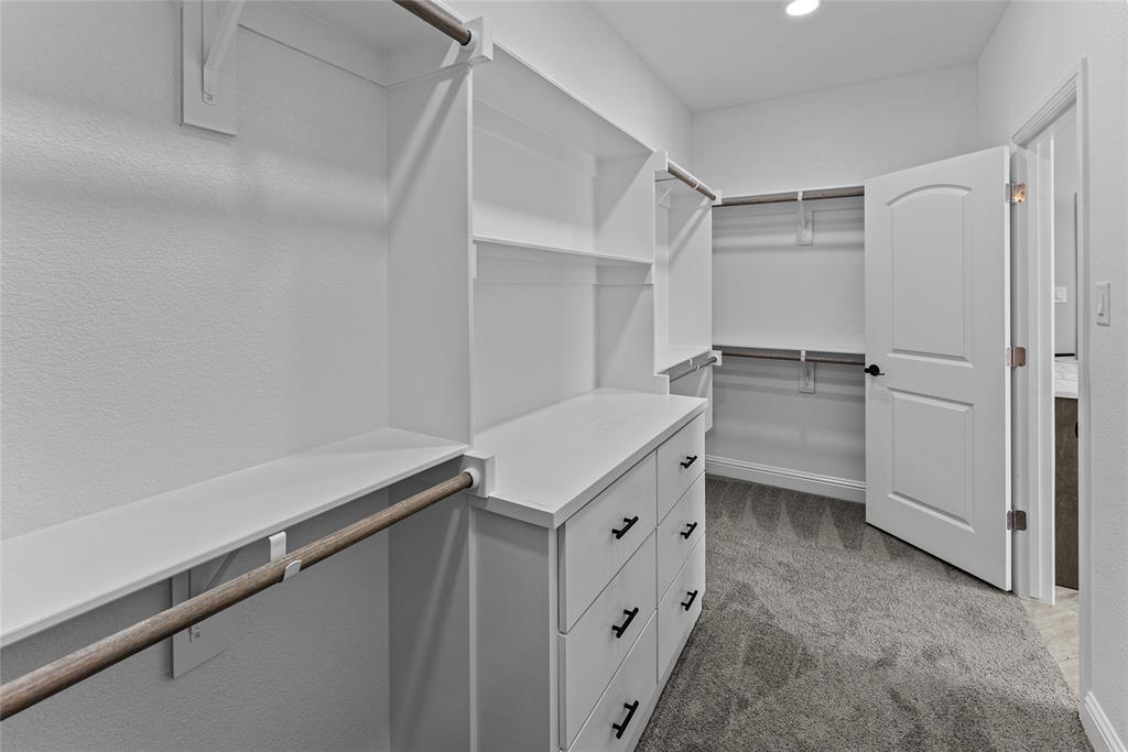 8806 County Road 1229 Godley, TX 76044 - Photo 15 of 33 a kitchen with white cabinets and white appliances