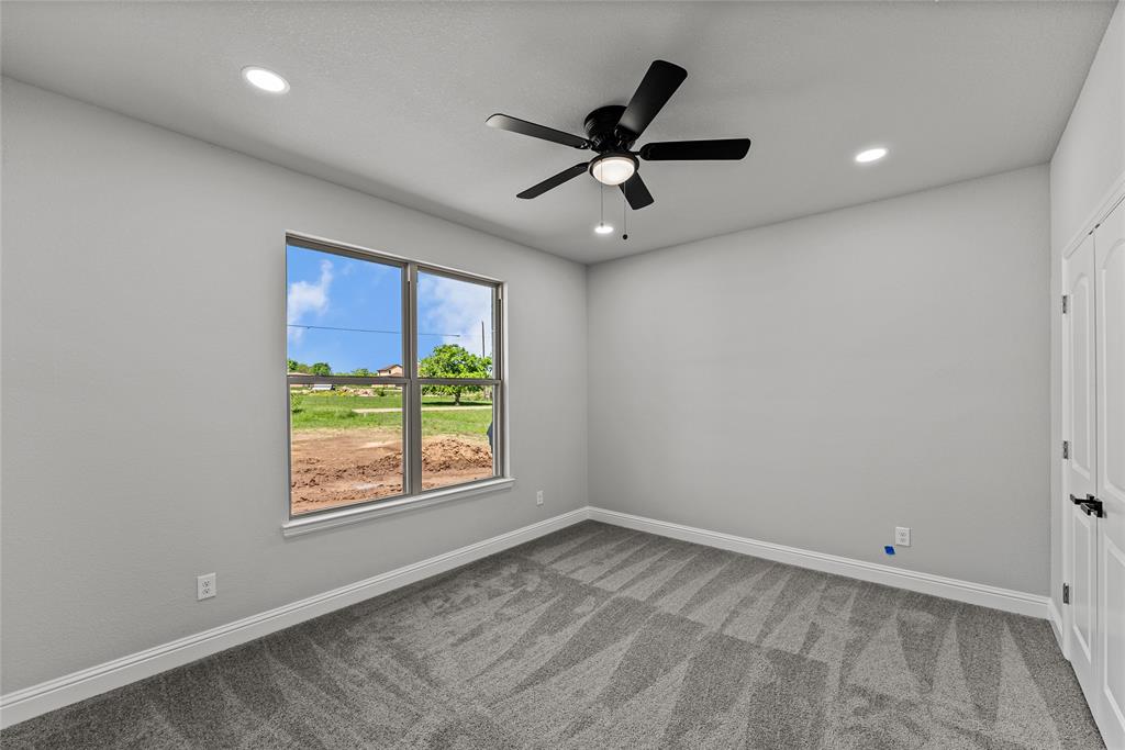 8806 County Road 1229 Godley, TX 76044 - Photo 18 of 33 an empty room with windows and ceiling fan