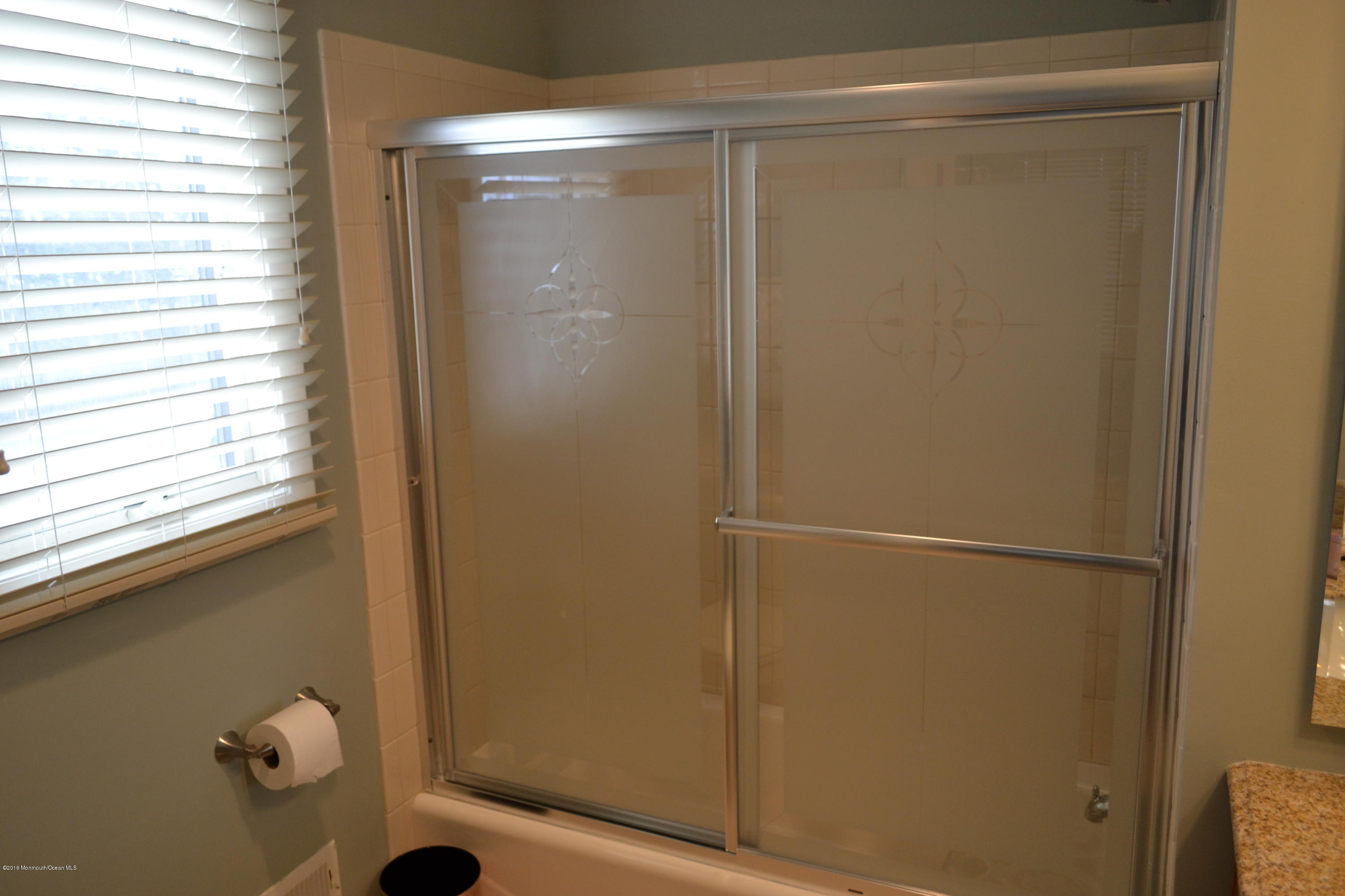 8 Hidden Harbor Drive Point Pleasant, NJ 08742 - Photo 11 of 37 a bathroom with a glass shower door