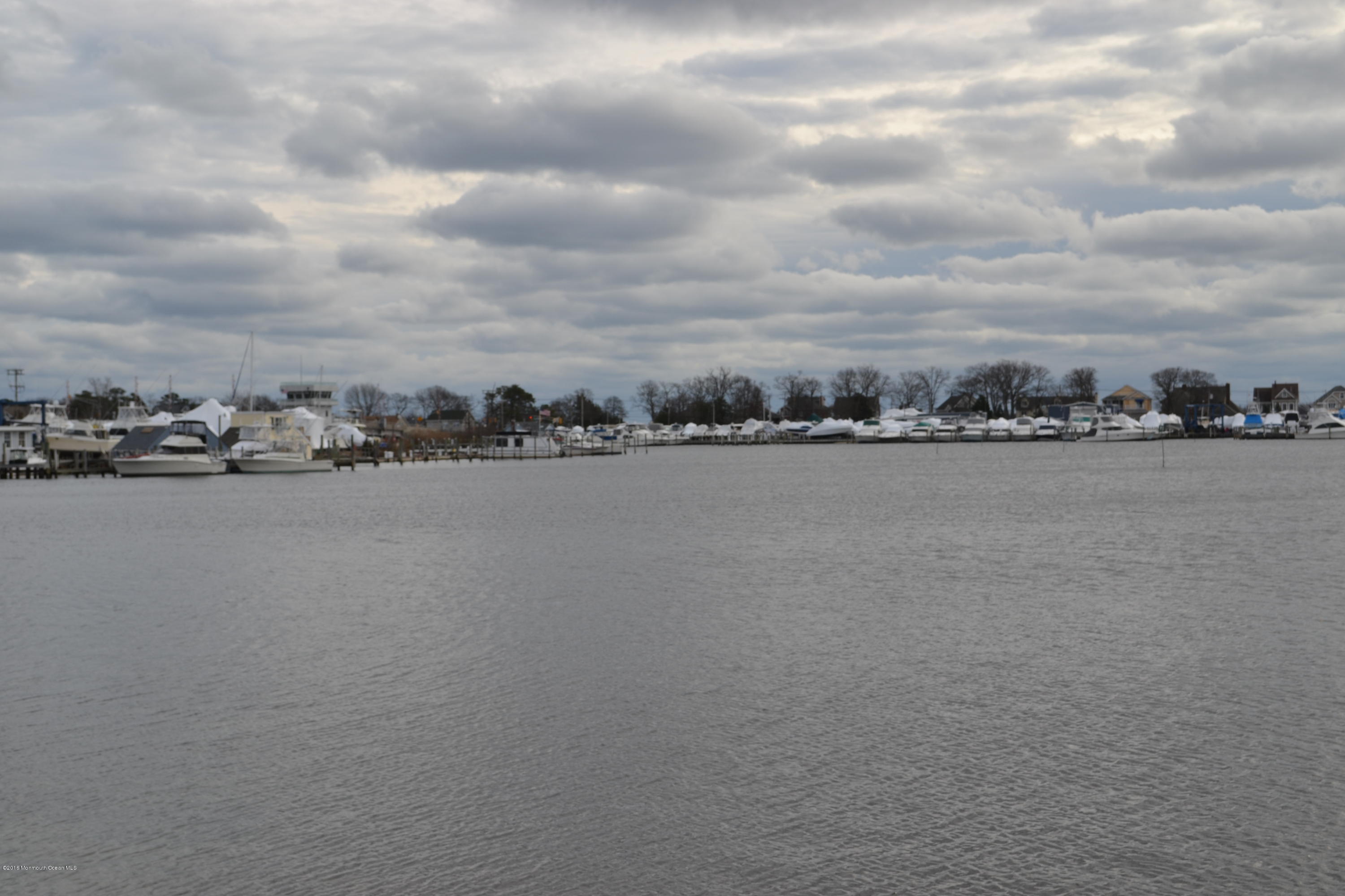 8 Hidden Harbor Drive Point Pleasant, NJ 08742 - Photo 2 of 37 a view of a lake with houses in the back