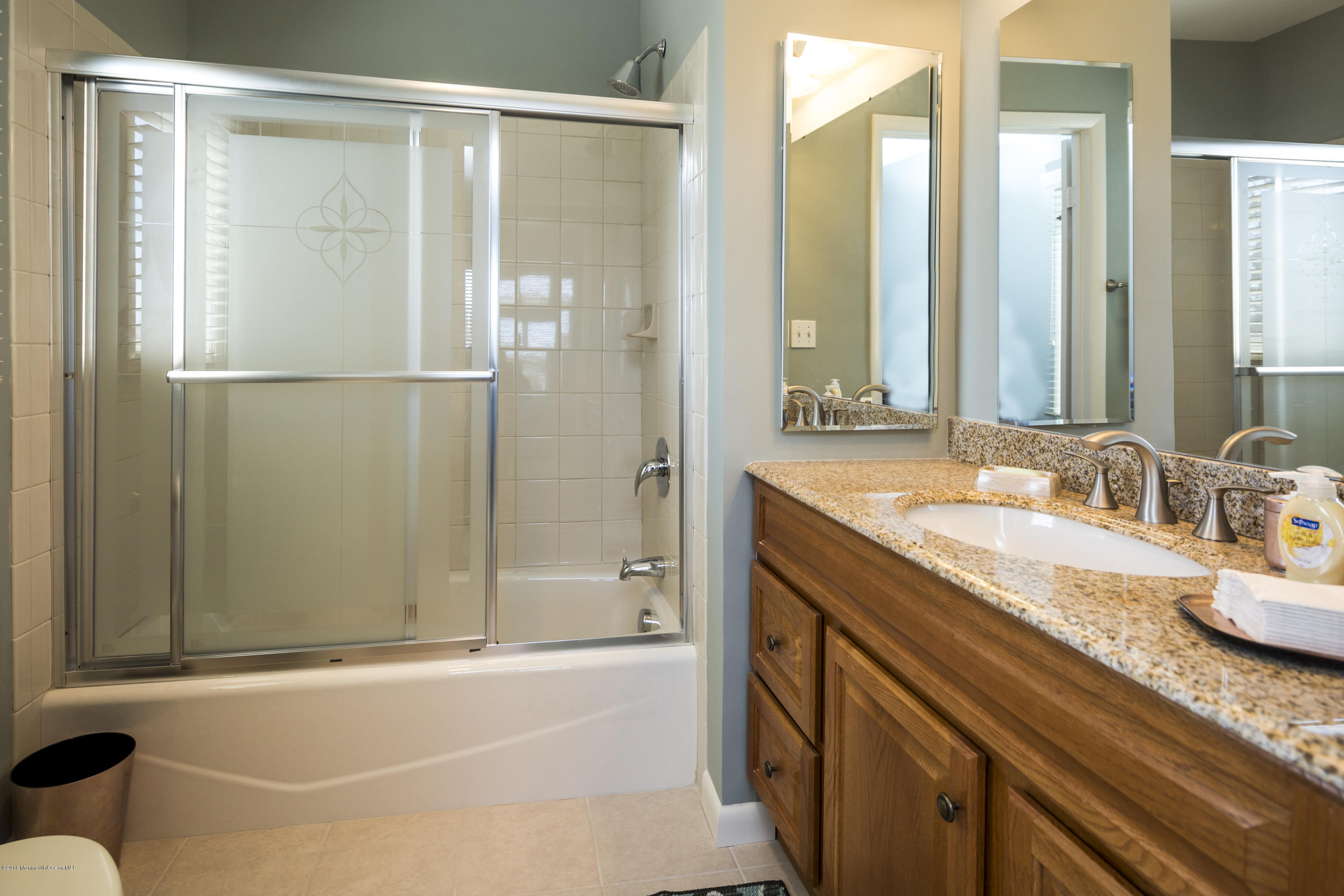 8 Hidden Harbor Drive Point Pleasant, NJ 08742 - Photo 32 of 37 a bathroom with a granite countertop sink mirror and a bathtub
