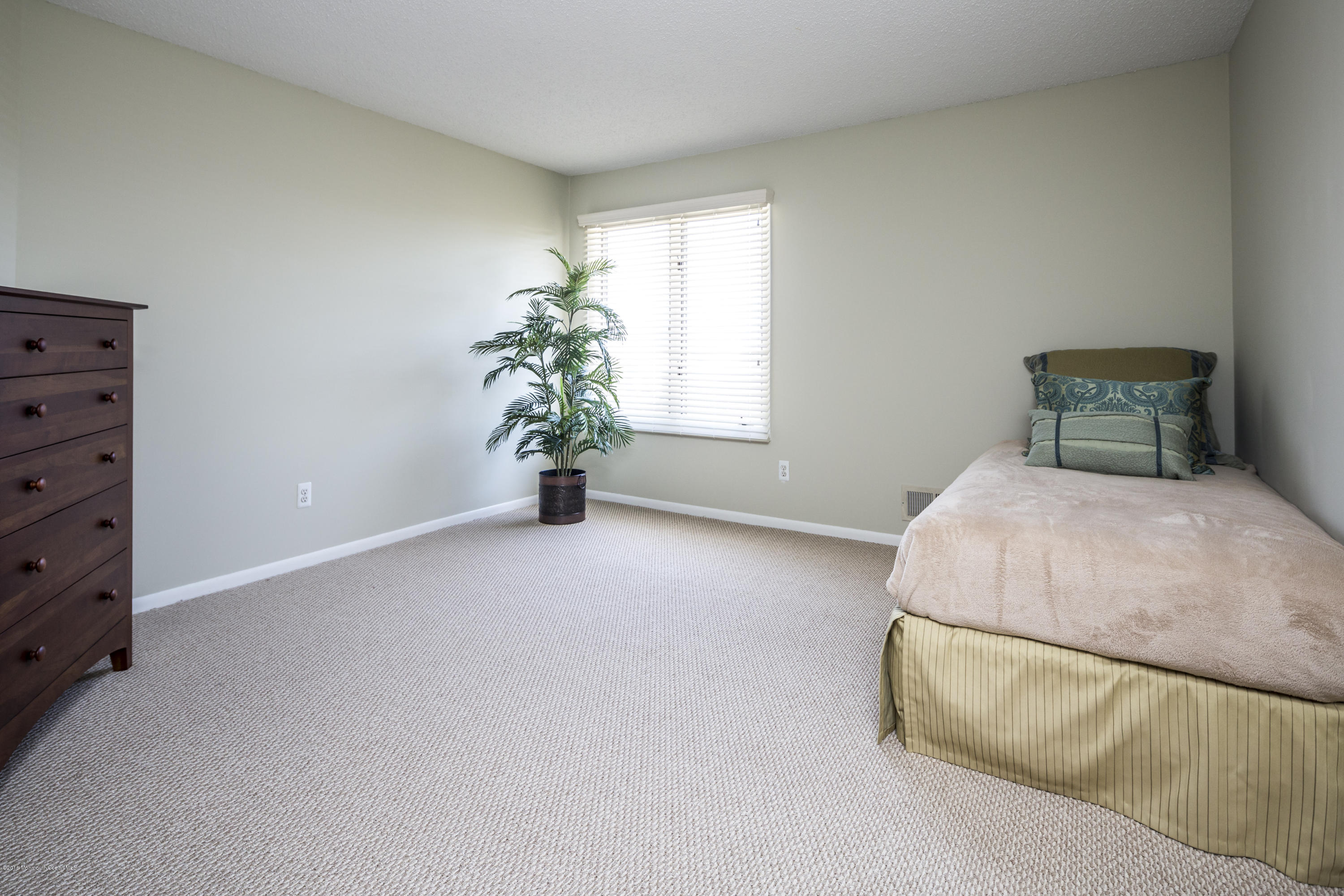 8 Hidden Harbor Drive Point Pleasant, NJ 08742 - Photo 33 of 37 a bed room with a bed and a potted plant