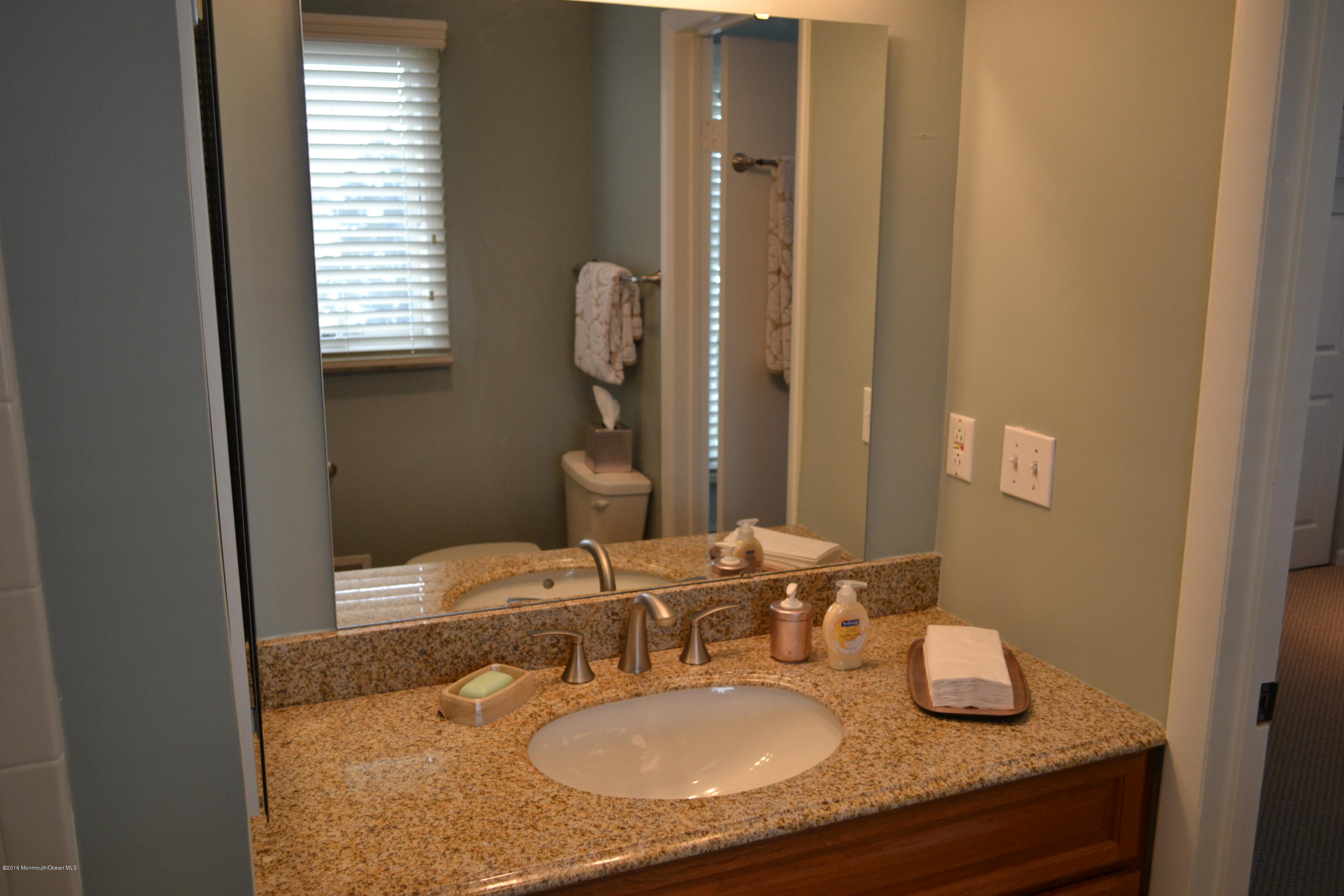 8 Hidden Harbor Drive Point Pleasant, NJ 08742 - Photo 4 of 37 a bathroom with a granite countertop sink and a mirror