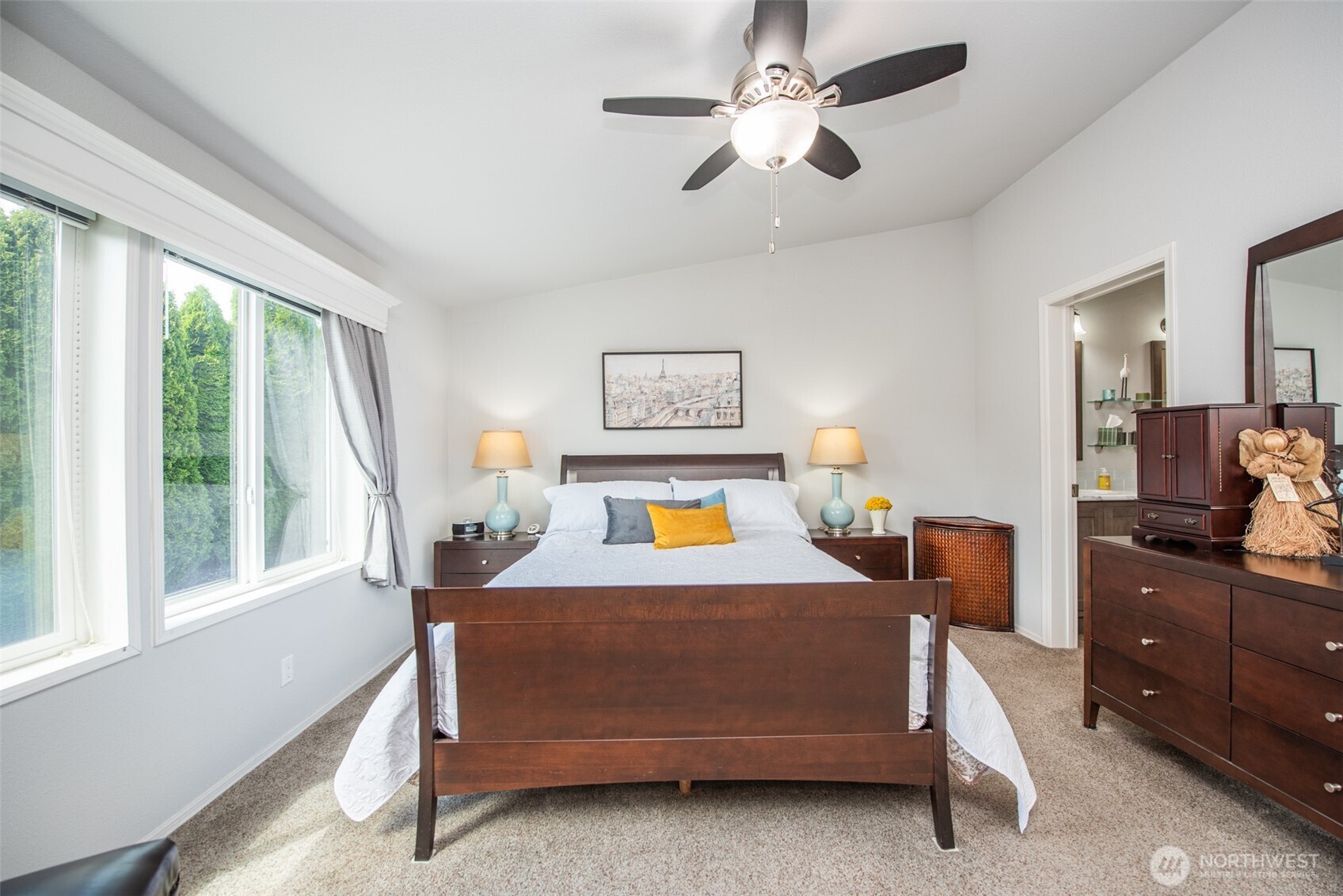 720 West Heritage Loop Sequim, WA 98382 - Photo 19 of 35 a bedroom with a bed chandelier and a window