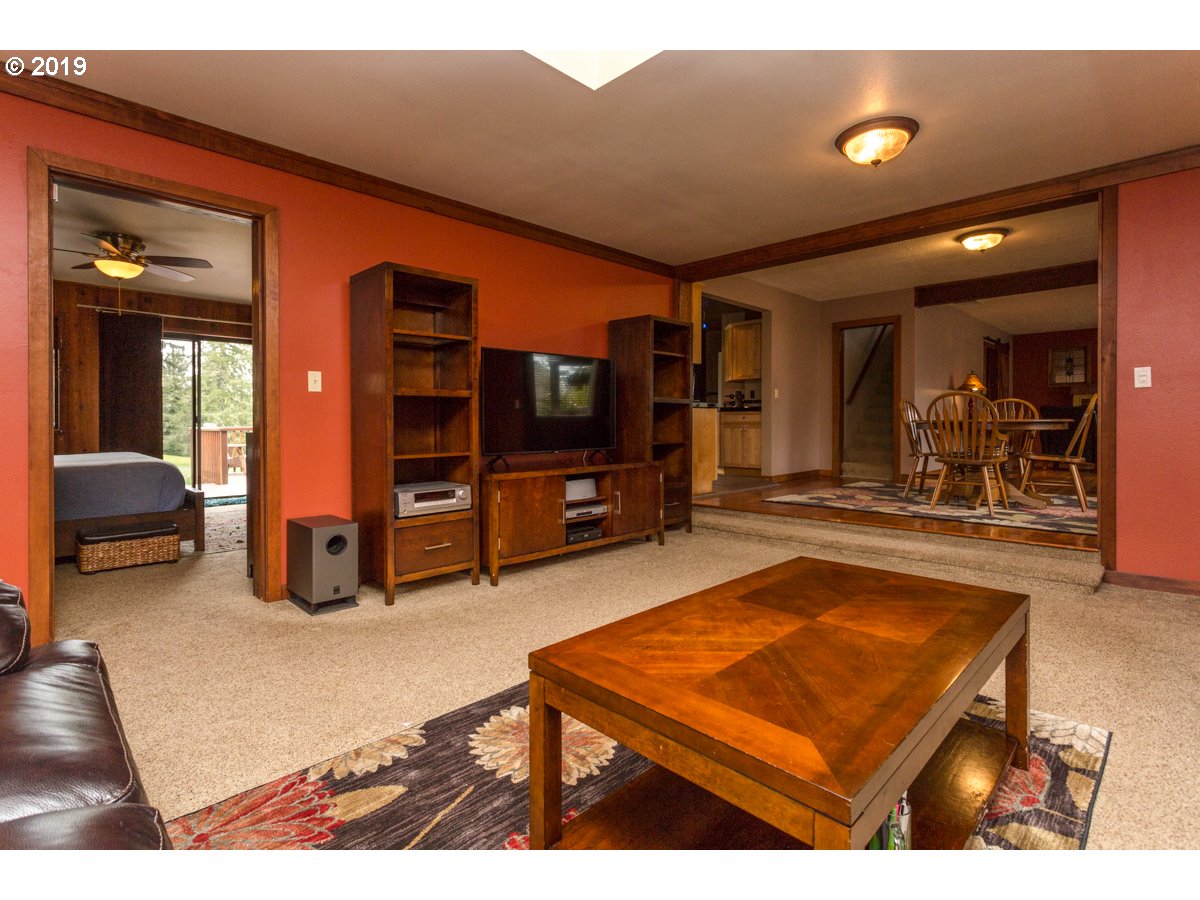 91978 Lewis And Clark Road Astoria, OR 97103 - Photo 8 of 32 a living room with furniture flat screen tv and gym equipment