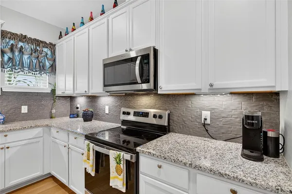 a kitchen with stainless steel appliances granite countertop a refrigerator sink and cabinets