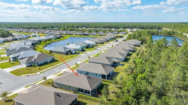 an aerial view of residential houses with outdoor space