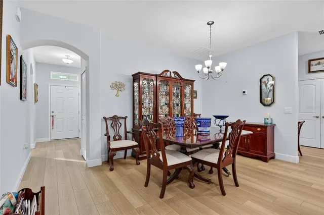 a view of a dining room with furniture and chandelier