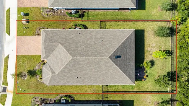 an aerial view of a house with a yard