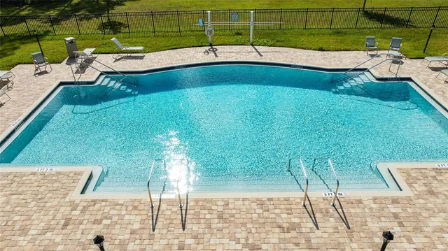 a view of a swimming pool with a patio