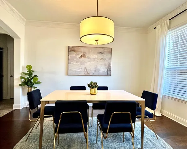 a view of a dining room with a table and chairs