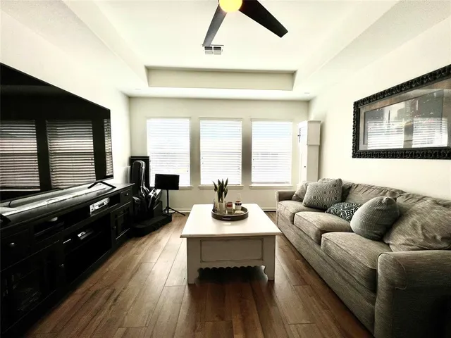 a living room with furniture fireplace and a large window