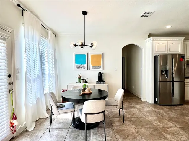 a dining room with furniture and window