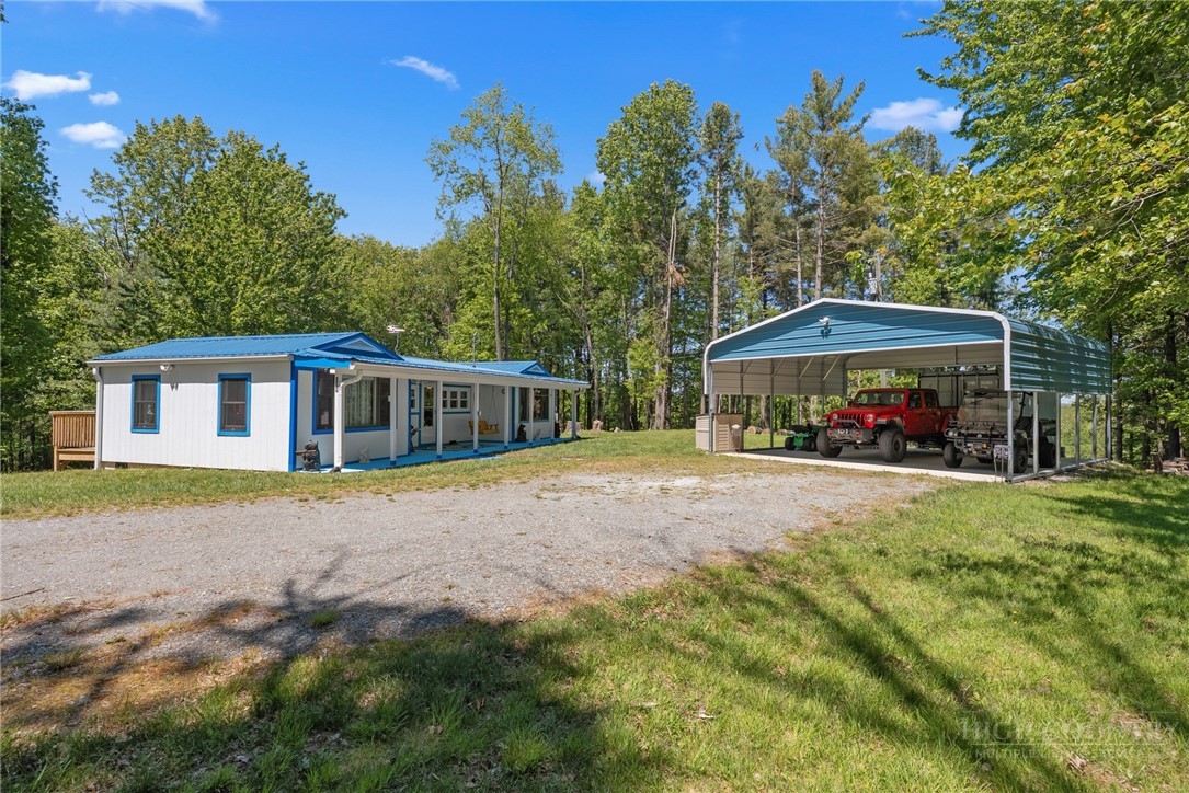 154 Folger Road Sparta, NC 28675 - Photo 23 of 37 a view of a house with backyard and a trees