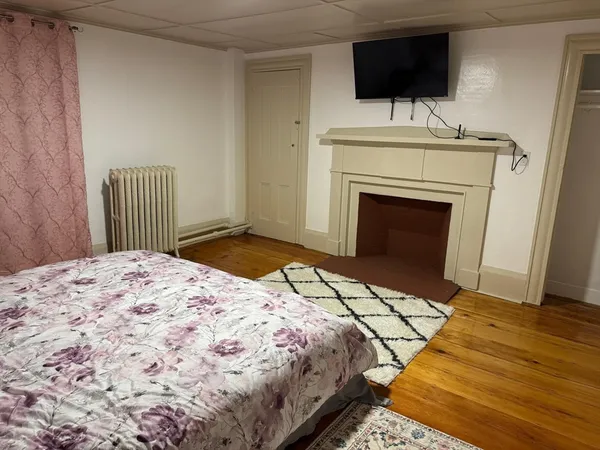 a bedroom with a bed and a flat screen tv