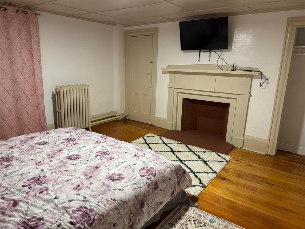 367 Maple Street, Unit MULTIFAMLY Danvers, MA 01923 - Photo 8 of 26 a bedroom with a bed and a flat screen tv