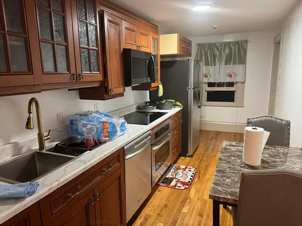 a kitchen with granite countertop a sink and a stove top oven