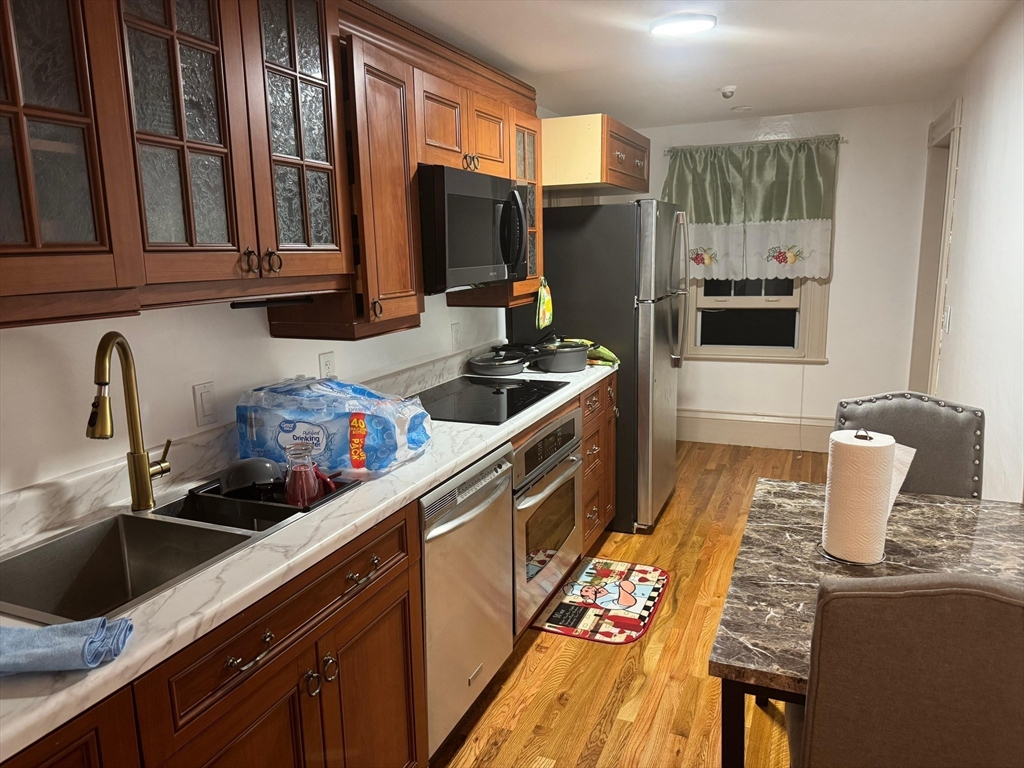 367 Maple Street, Unit MULTIFAMLY Danvers, MA 01923 - Photo 10 of 26 a kitchen with granite countertop a sink and a stove top oven