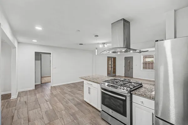 a kitchen with a stove and a refrigerator