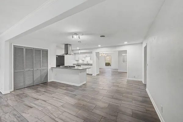 a large kitchen with kitchen island a sink stainless steel appliances and cabinets