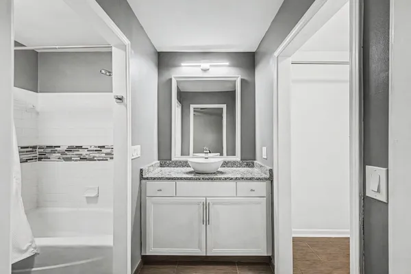 a bathroom with a bathtub and a shower