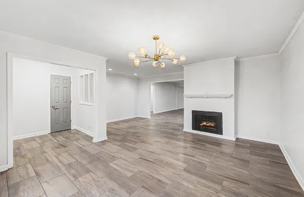 a view of an empty room with a fireplace