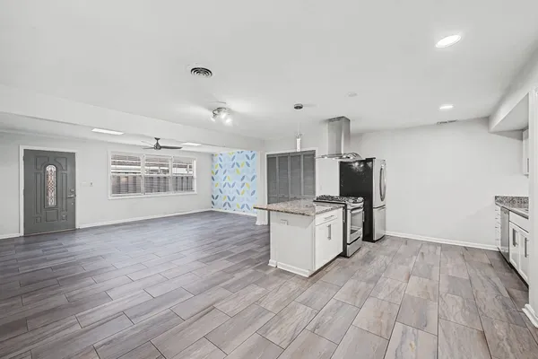 a view of kitchen with sink microwave and refrigerator