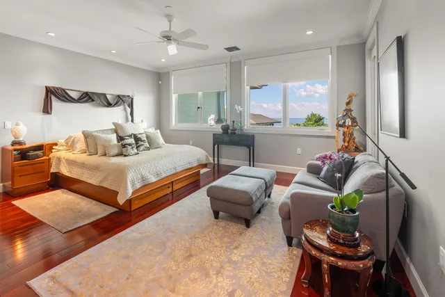 a bedroom with a bed and ceiling fan