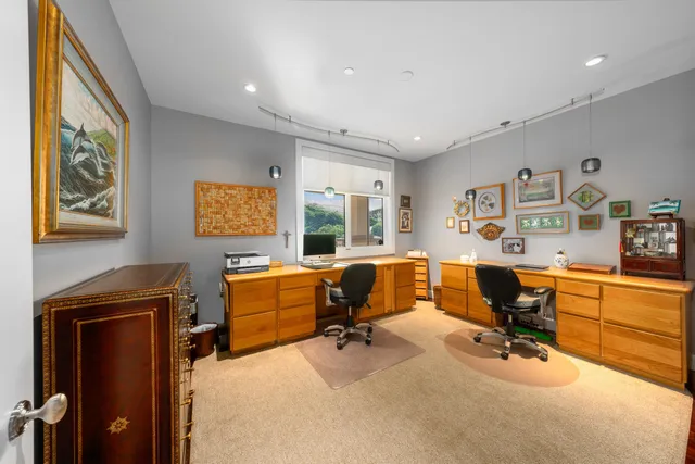 a view of a livingroom with workspace and a couch