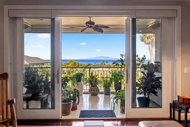 a living room filled with furniture and a potted plant