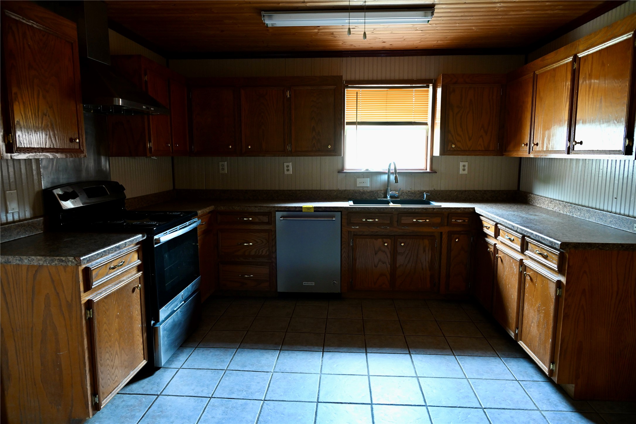 252 Bastrop Street Angleton, TX 77515 - Photo 17 of 28 a kitchen with a sink stove top oven and cabinets